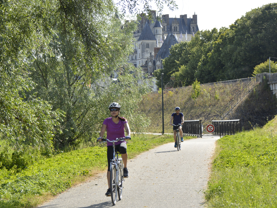 Vue sur la Loire à vélo avec 2 cyclistes. En arrière plan, le château d'Amboise.